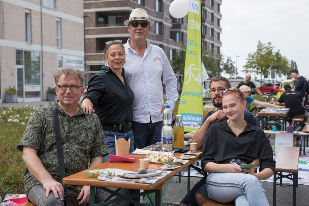 Fünf Personen sitzen am Tisch. Es ist das Team der Überseewiese. Auf ihrem Tisch gibt es Fotos und kleine Häppchen.