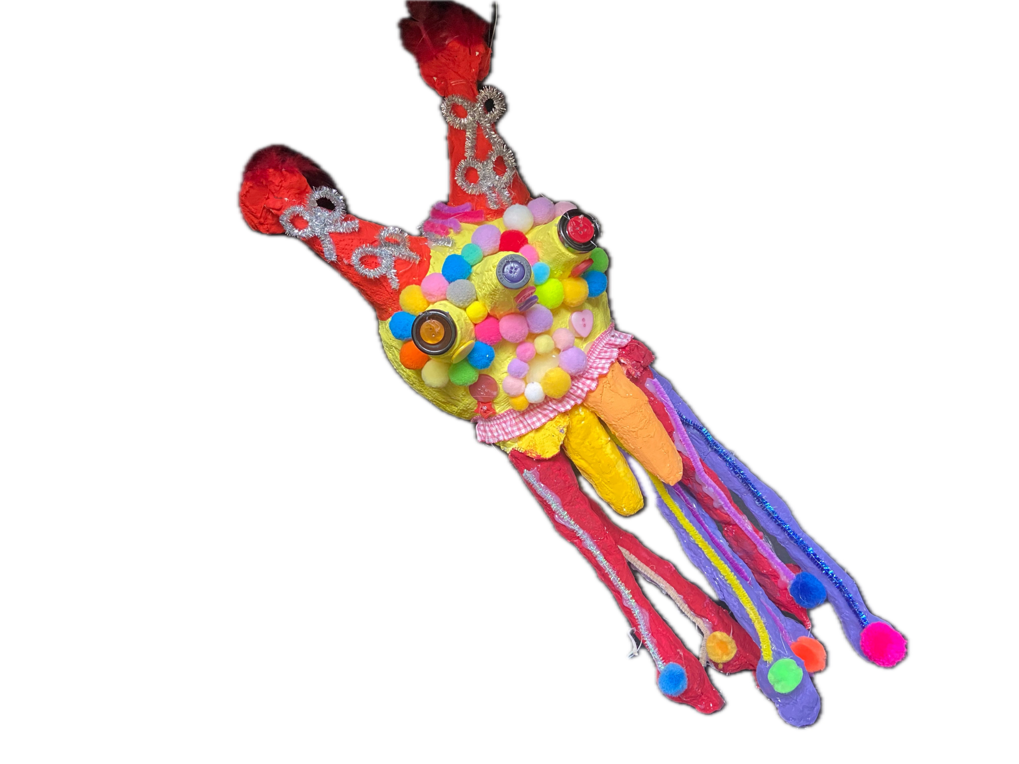 Ein Kuscheltier wurde mit bunten Knöpfen dekoriert.