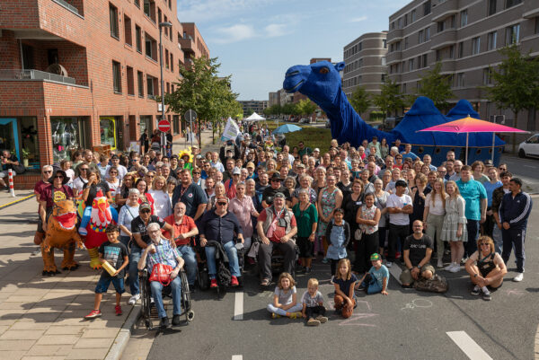 Gemeinsames Gruppenfoto mit circa 100 Personen auf dem Kommodore-Johnsen-Boulevard. Auch ein riesen großes Blaues Kamel steht auf der Straße.